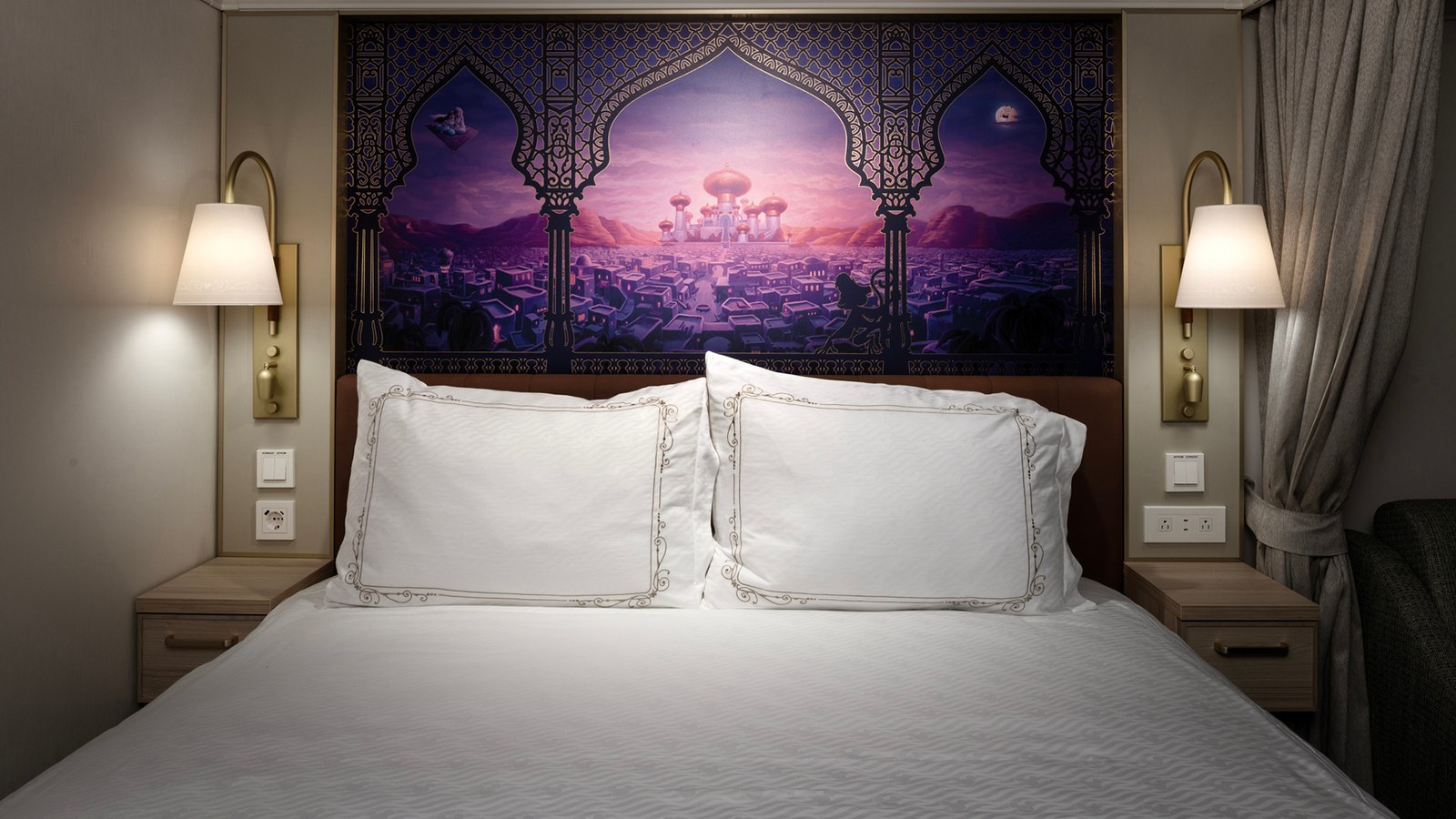 Oceanview stateroom with a themed headboard mural on the Disney Treasure