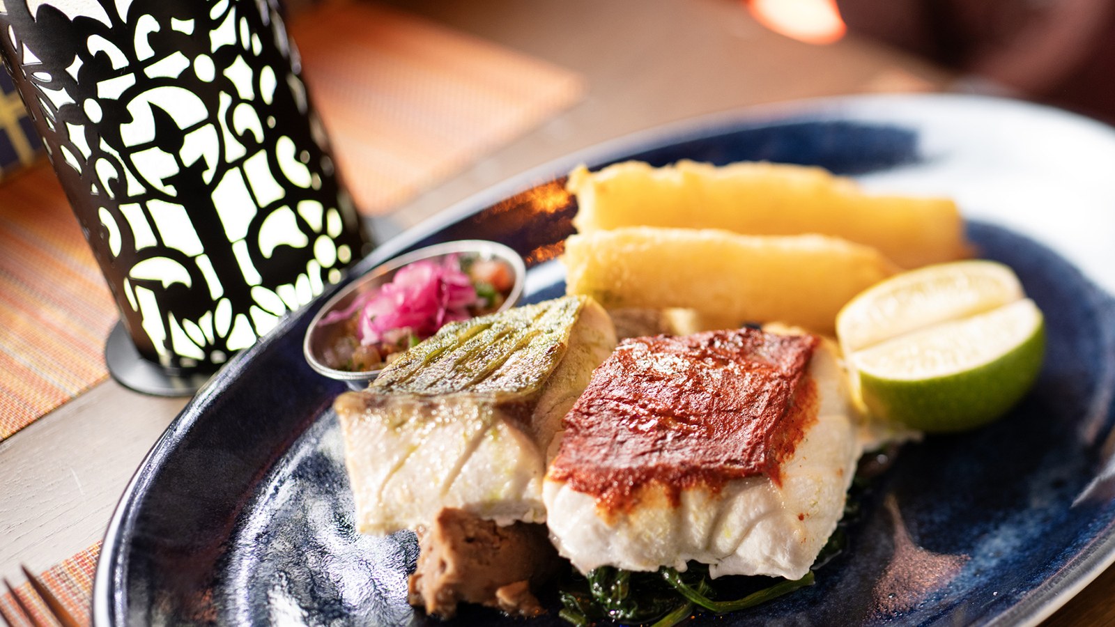 Pan seared adobo spiced sea bass served on a talavera plate at Plaza de Coco on the Disney Treasure