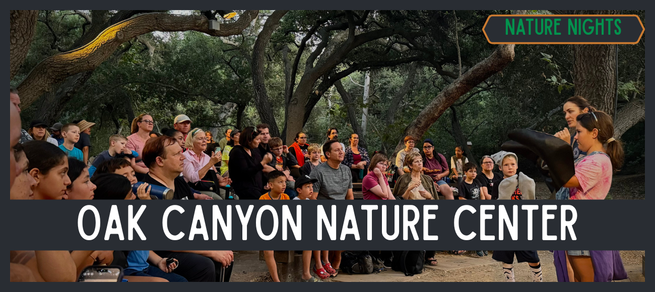 Families attending a nature program under oak trees at Oak Canyon Nature Center