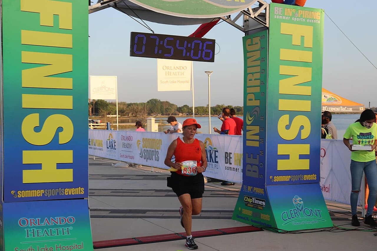 Runner crossing a finish line at Victory Pointe Park in Clermont