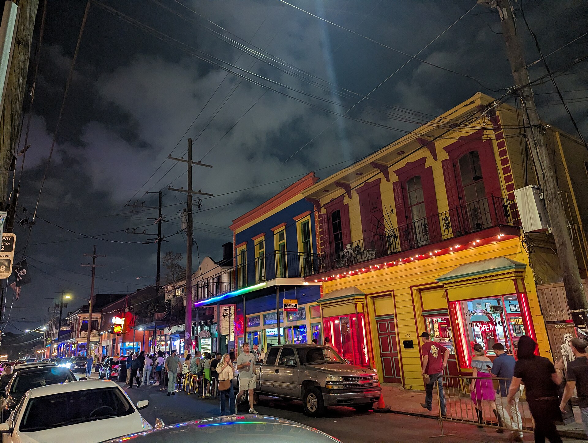 Neon signs and crowds along Frenchmen Street in New Orleans at night