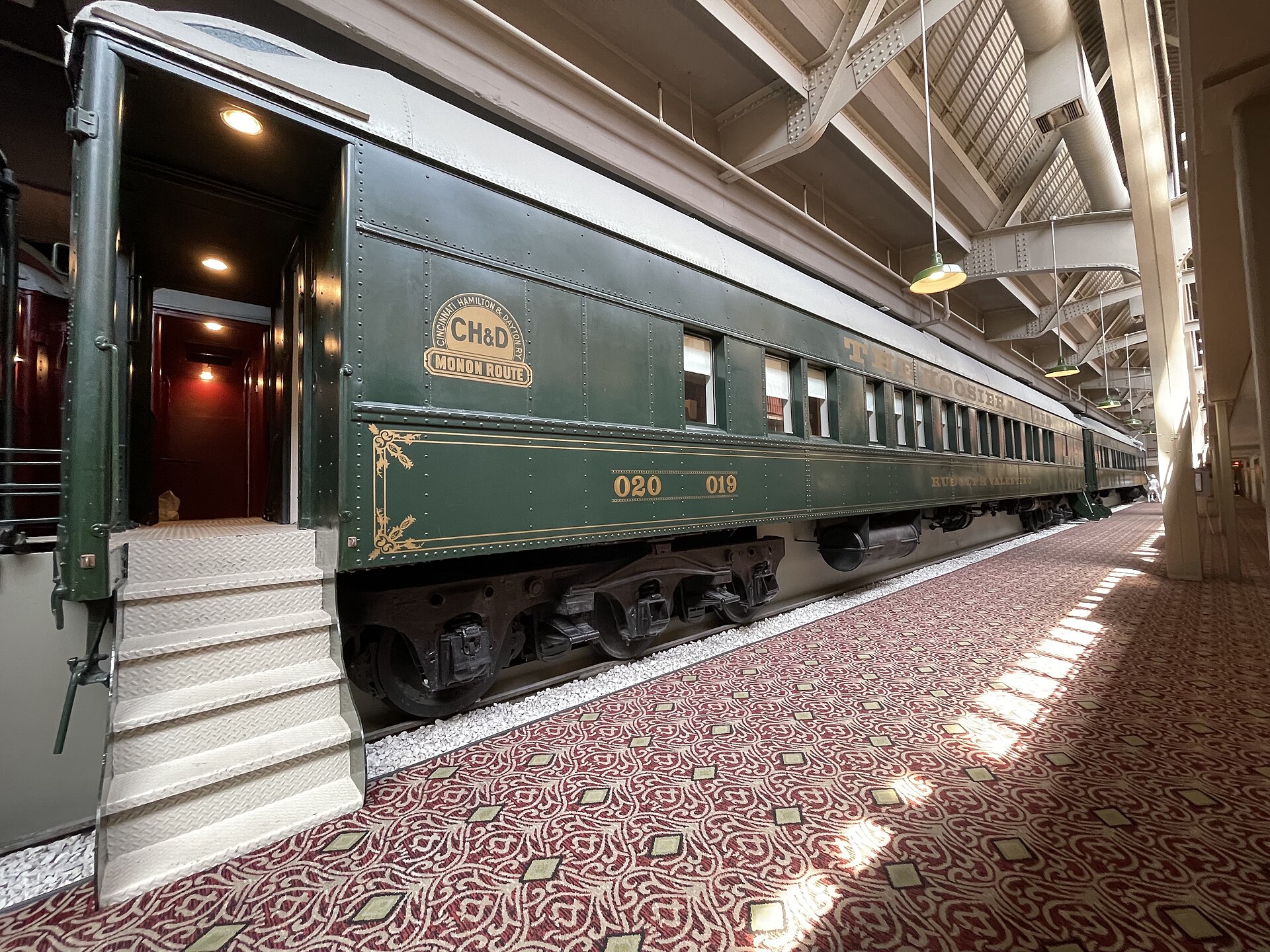 A beautifully restored historic Pullman sleeping compartment with upper and lower wooden berths.