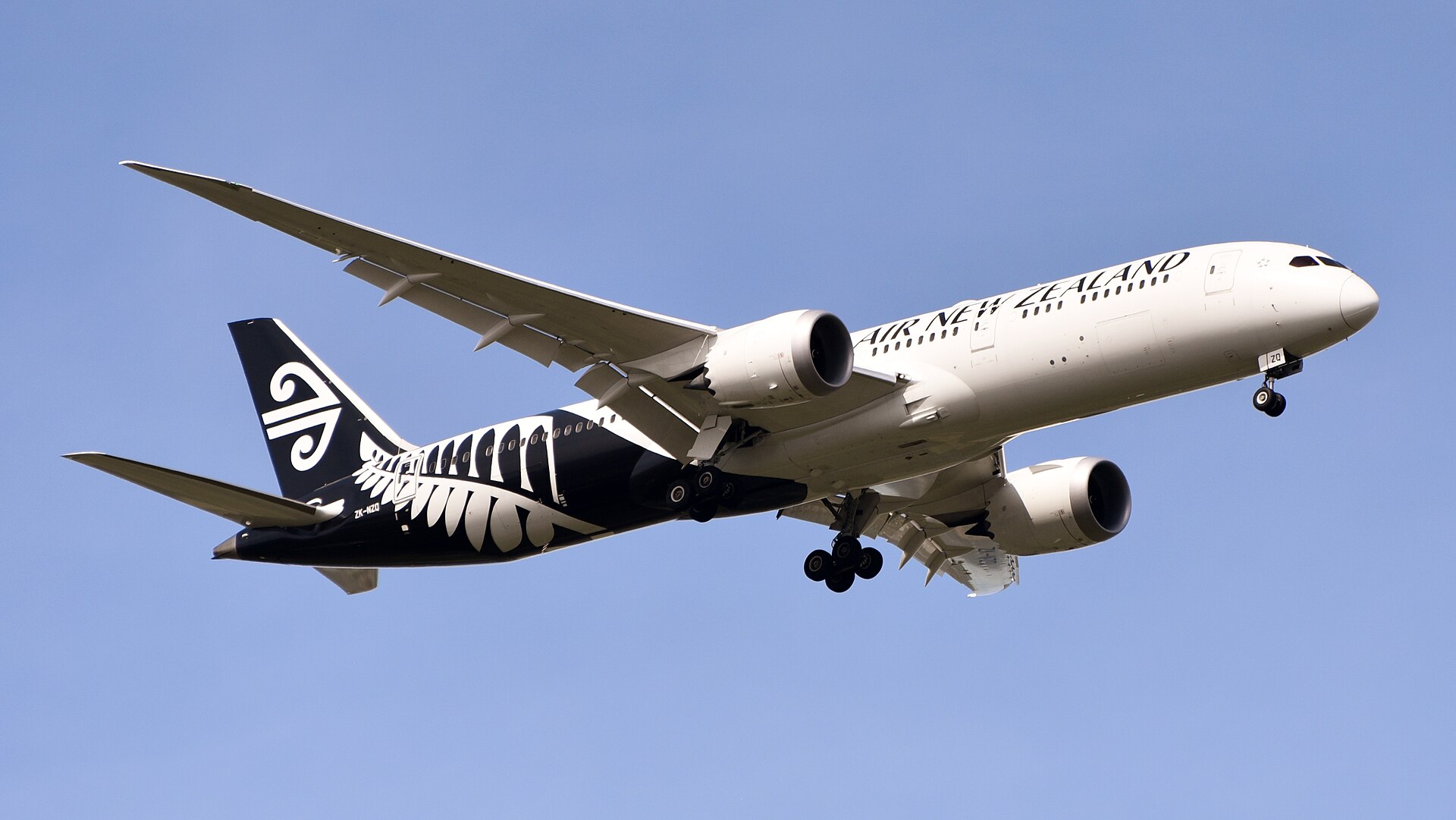 An Air New Zealand Boeing 787-9 Dreamliner widebody jetliner on its final approach to land under a bright sky.