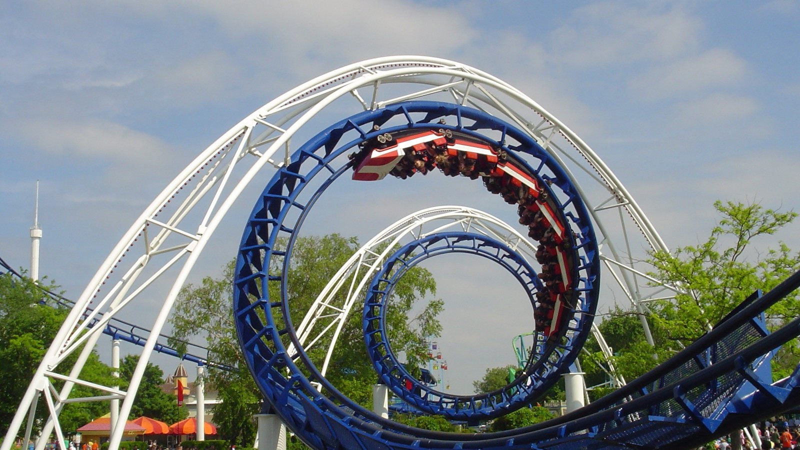 Cedar Point Corkscrew blue track and red-white-blue train in the double corkscrew elements
