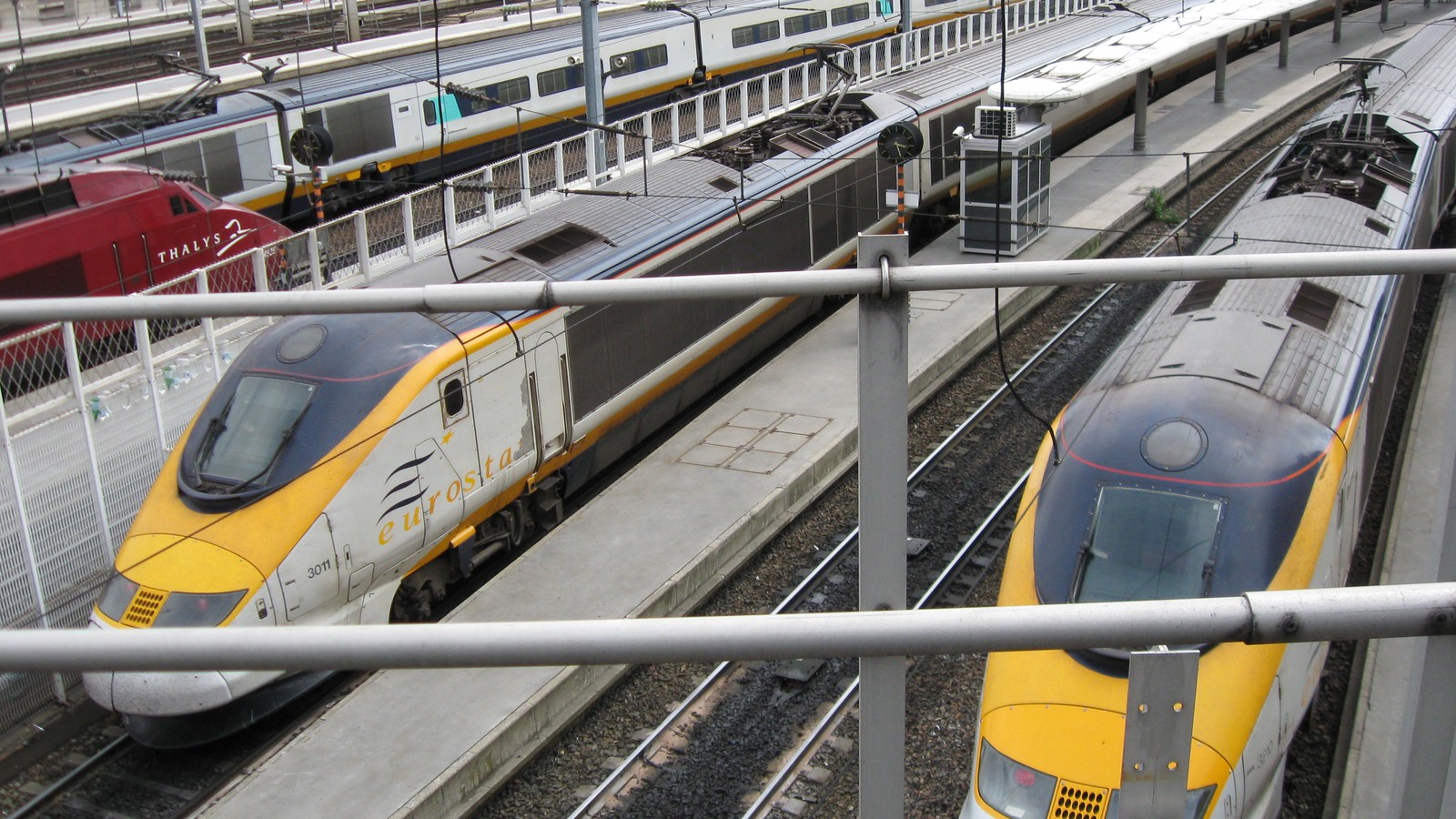 Yellow and gray Eurostar high-speed trains at Paris Gare du Nord platforms