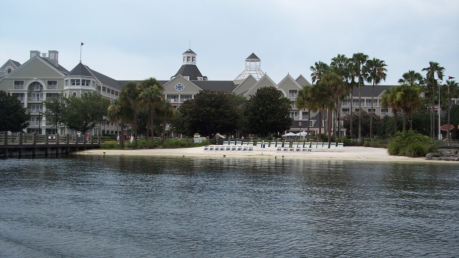 Exterior of Disney Yacht Club Resort across Crescent Lake water in afternoon light