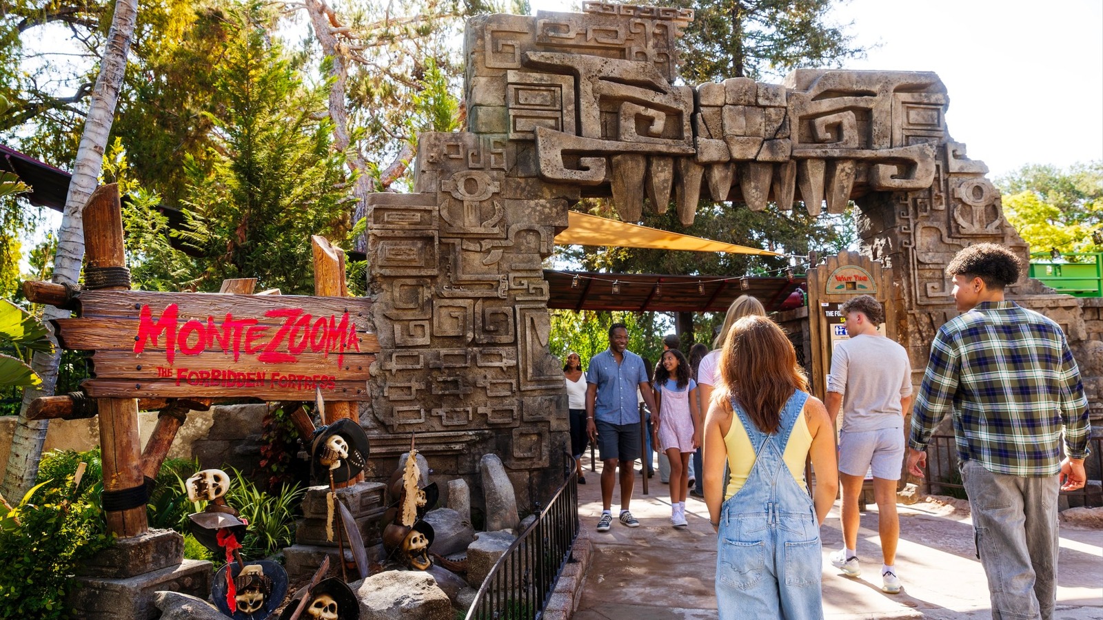 Guests walk under the MonteZOOMa The Forbidden Fortress entrance portal at Knotts Berry Farm