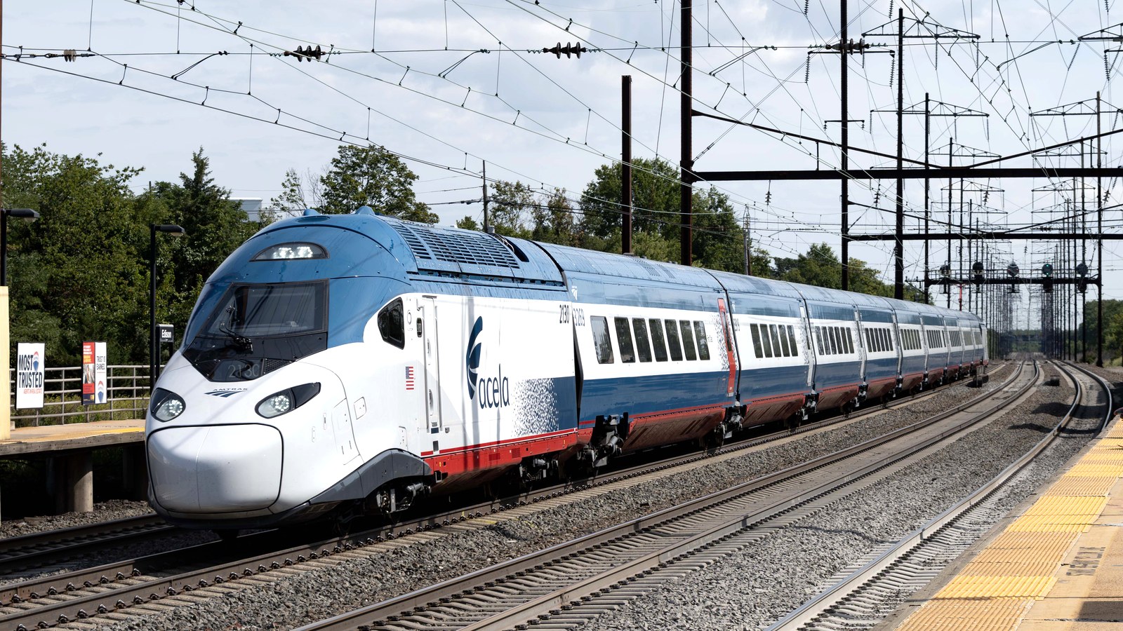 Amtrak NextGen Acela trainset on revenue run, brand-level image for Amtrak Vacations package promotion