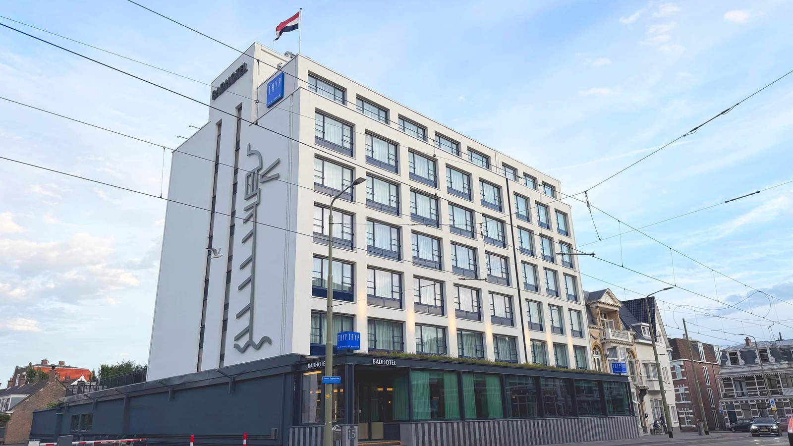 Night exterior of TRYP by Wyndham Badhotel The Hague Scheveningen with illuminated BADHOTEL and TRYP signs on Gevers Deynootweg