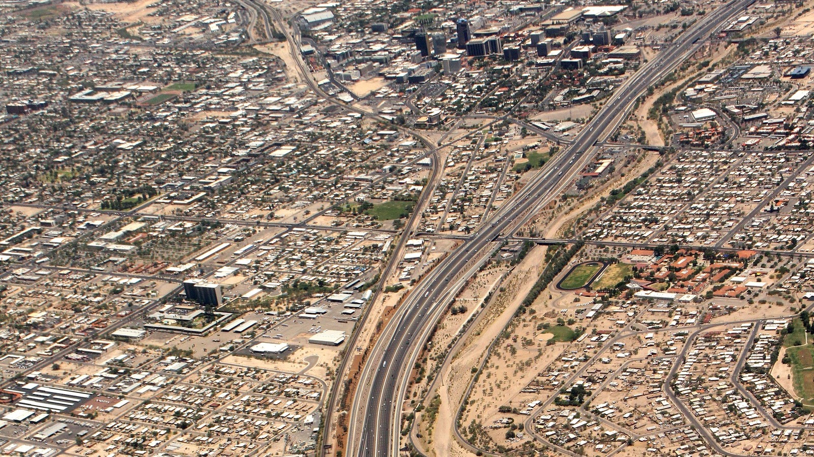 Aerial view of Interstate 10 running through Tucson with downtown buildings visible in the desert urban grid