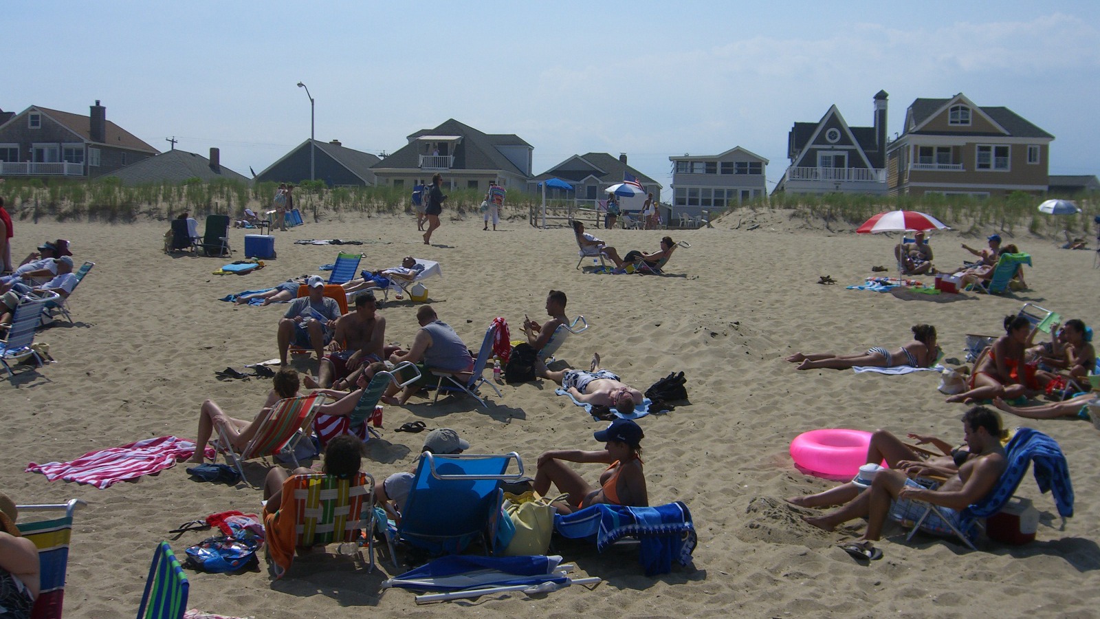 Manasquan Beach in New Jersey with sand, ocean, and beachfront residences along the boardwalk