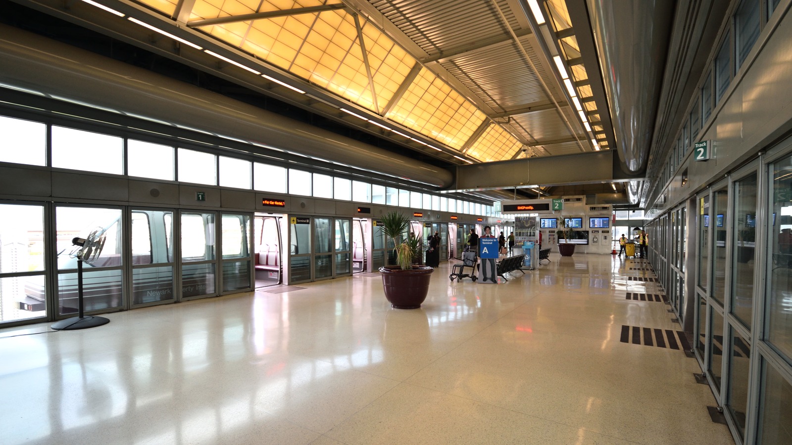 Newark Liberty Terminal A AirTrain station platform with monorail car at open platform doors