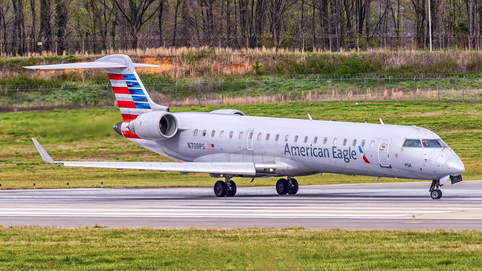 American Eagle Bombardier CRJ-700 regional jet on the ramp