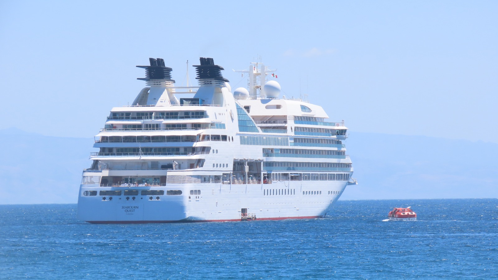 Seabourn Quest at sea with the hull name readable on the stern