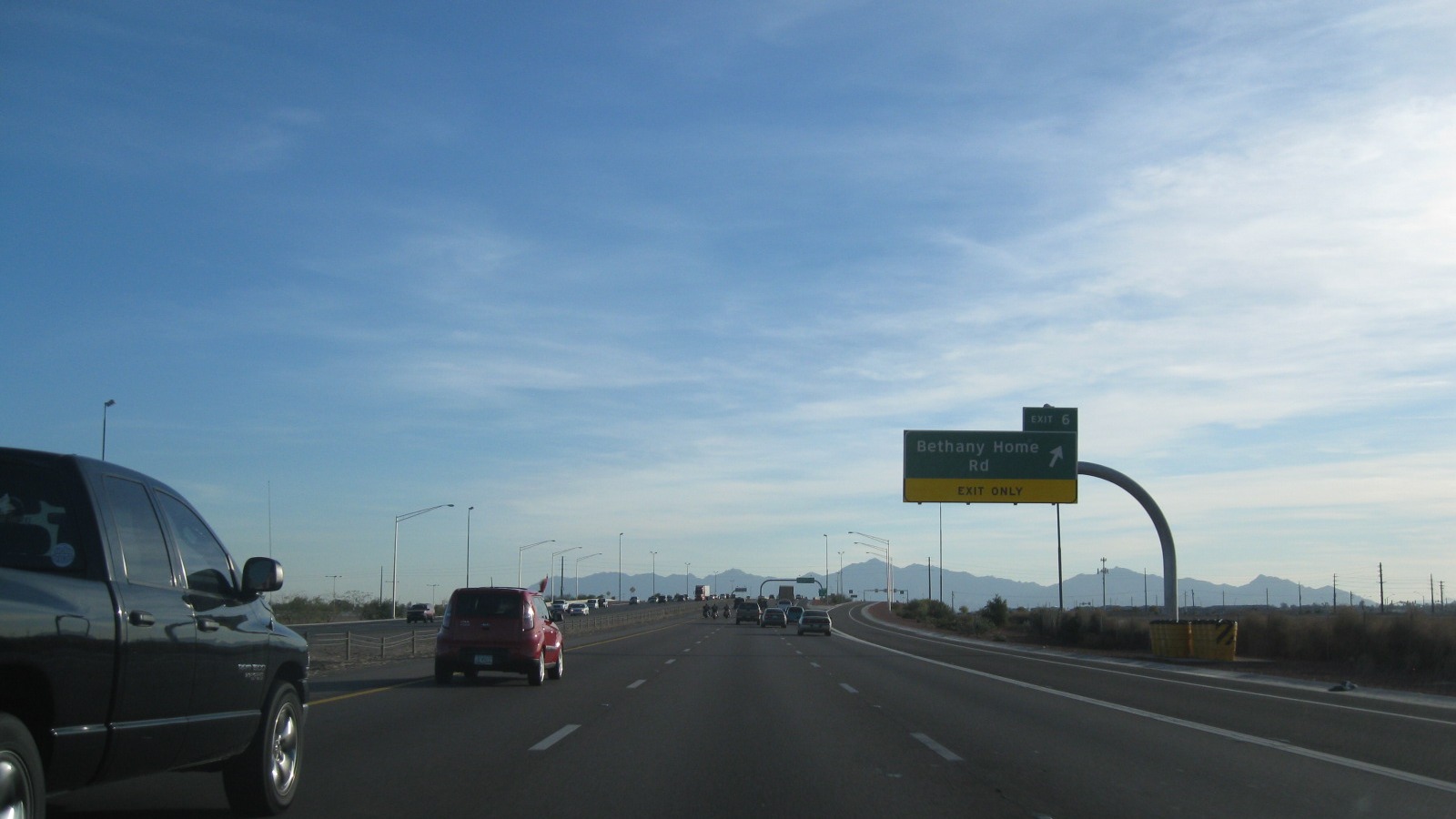 Arizona Loop 101 freeway through desert mountains north of Phoenix under clear sky