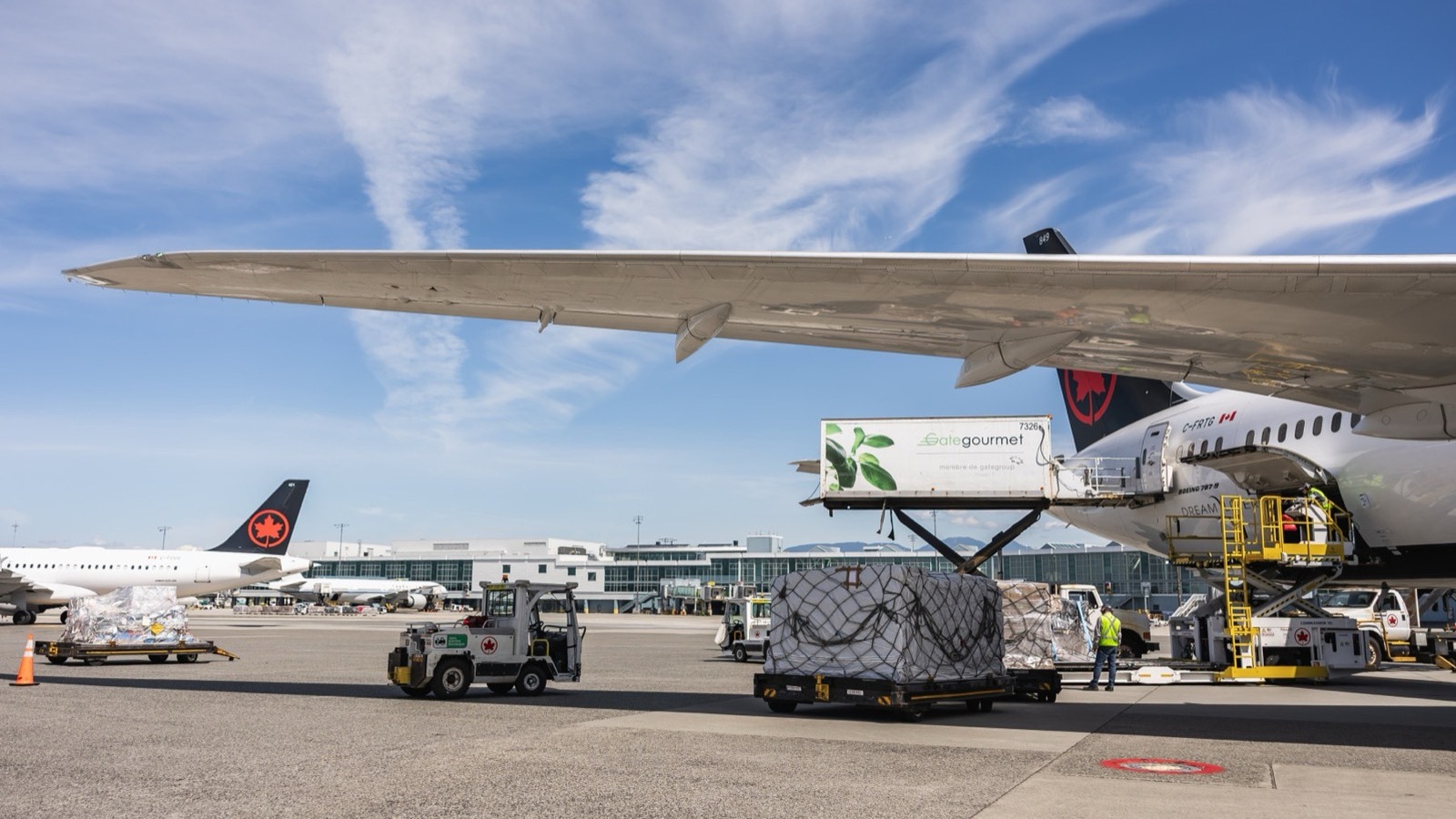 Air Canada aircraft on the Vancouver International Airport ramp with the YVR terminal behind