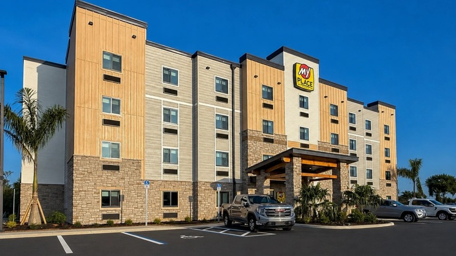 Exterior of My Place Hotel Port Charlotte with brand signage and porte-cochere