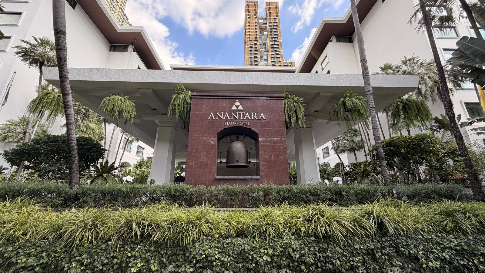 Anantara Siam Hotel exterior entrance canopy and bell monument in Bangkok, a GHA Discovery Asia brand property