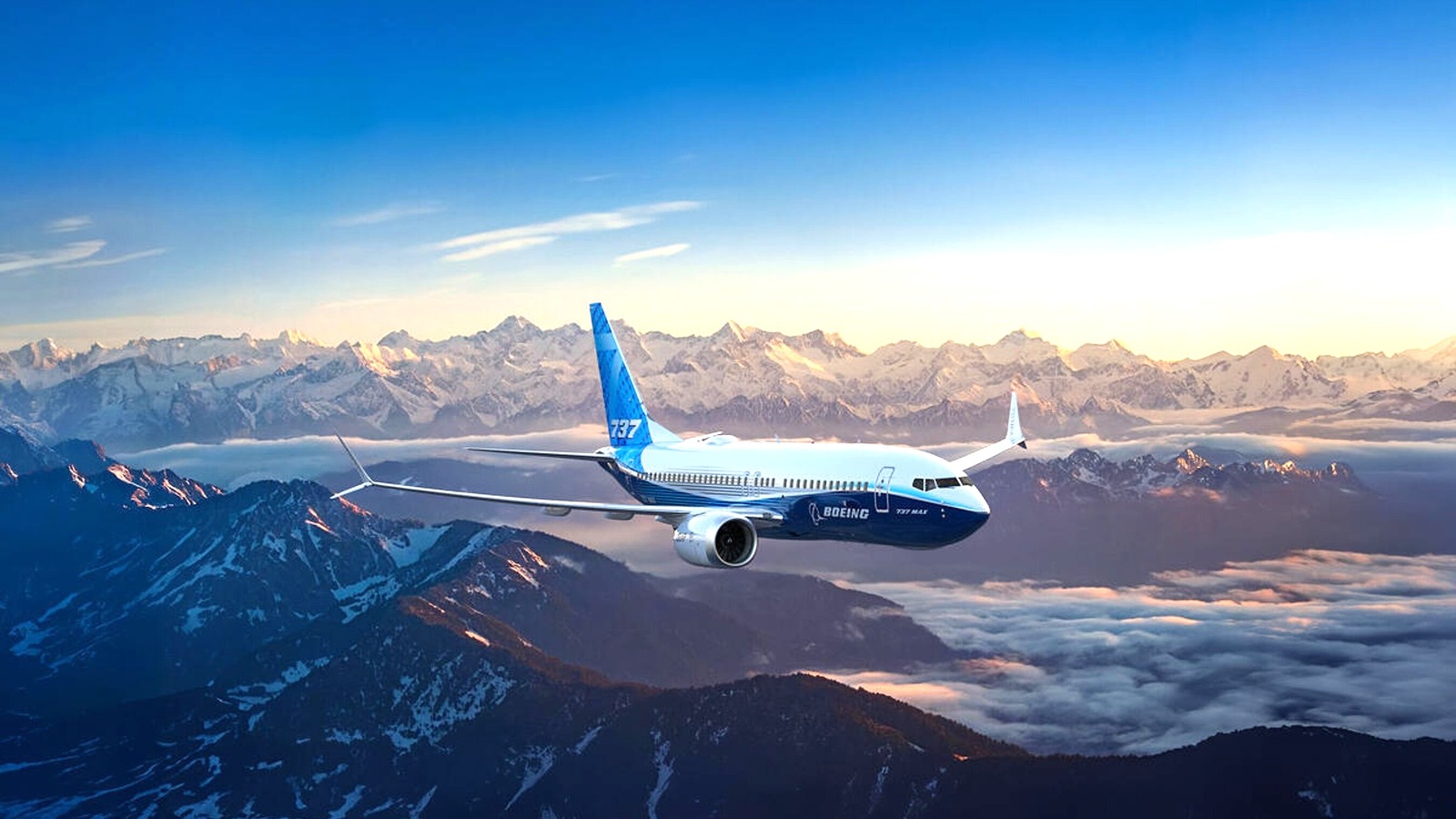 Boeing 737 MAX 7 aircraft in Boeing livery flying above mountains