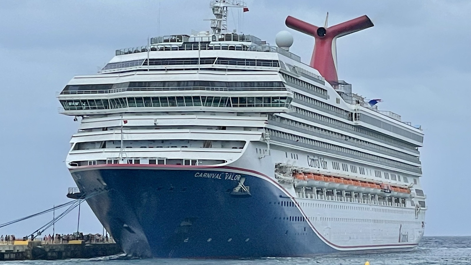 Carnival Valor with its current blue bow livery at a cruise pier