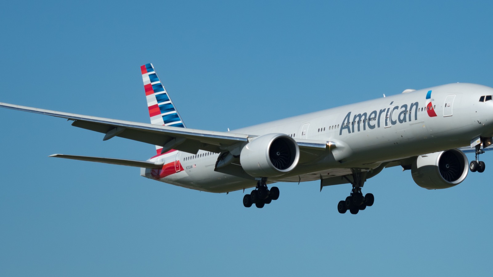 American Airlines Boeing 777-300ER taxiing in daylight with visible engine and livery