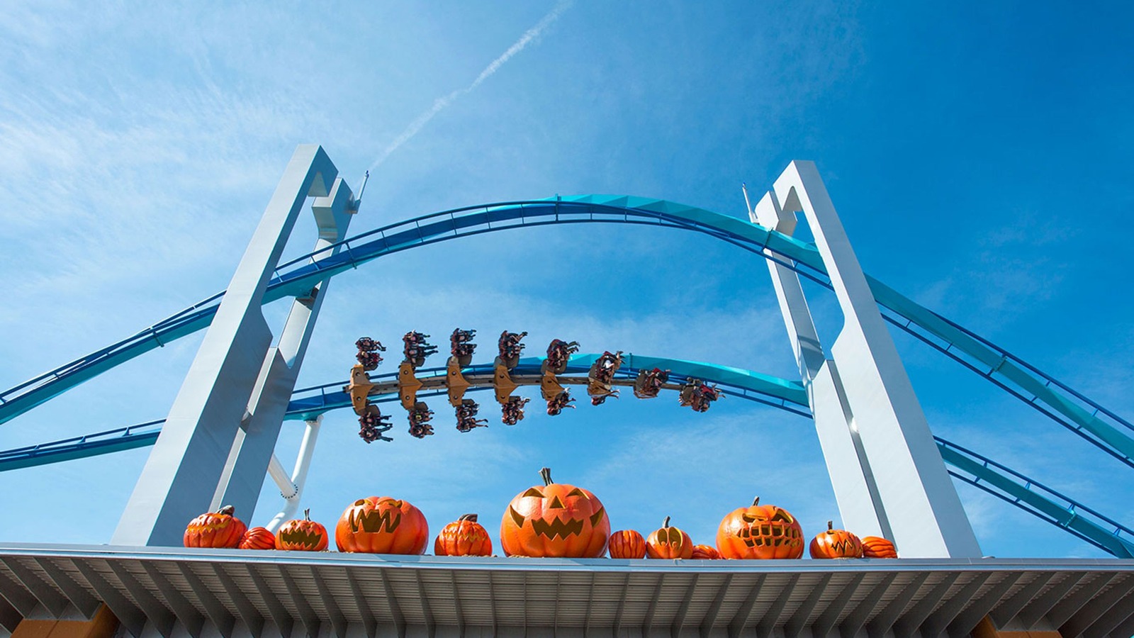 GateKeeper roller coaster above giant pumpkins at Cedar Point HalloWeekends entrance