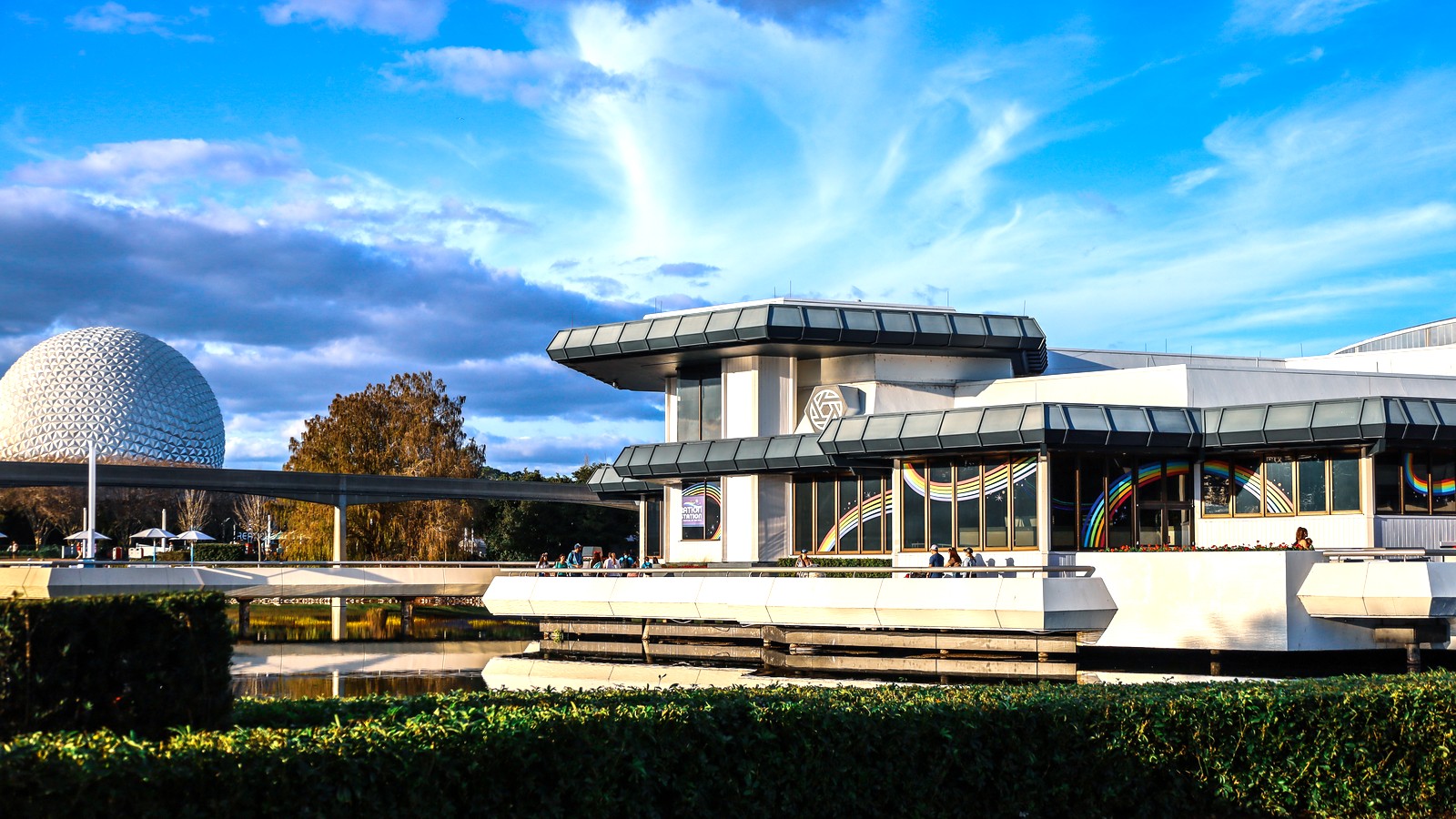 The Odyssey pavilion exterior at EPCOT with Spaceship Earth across the lagoon