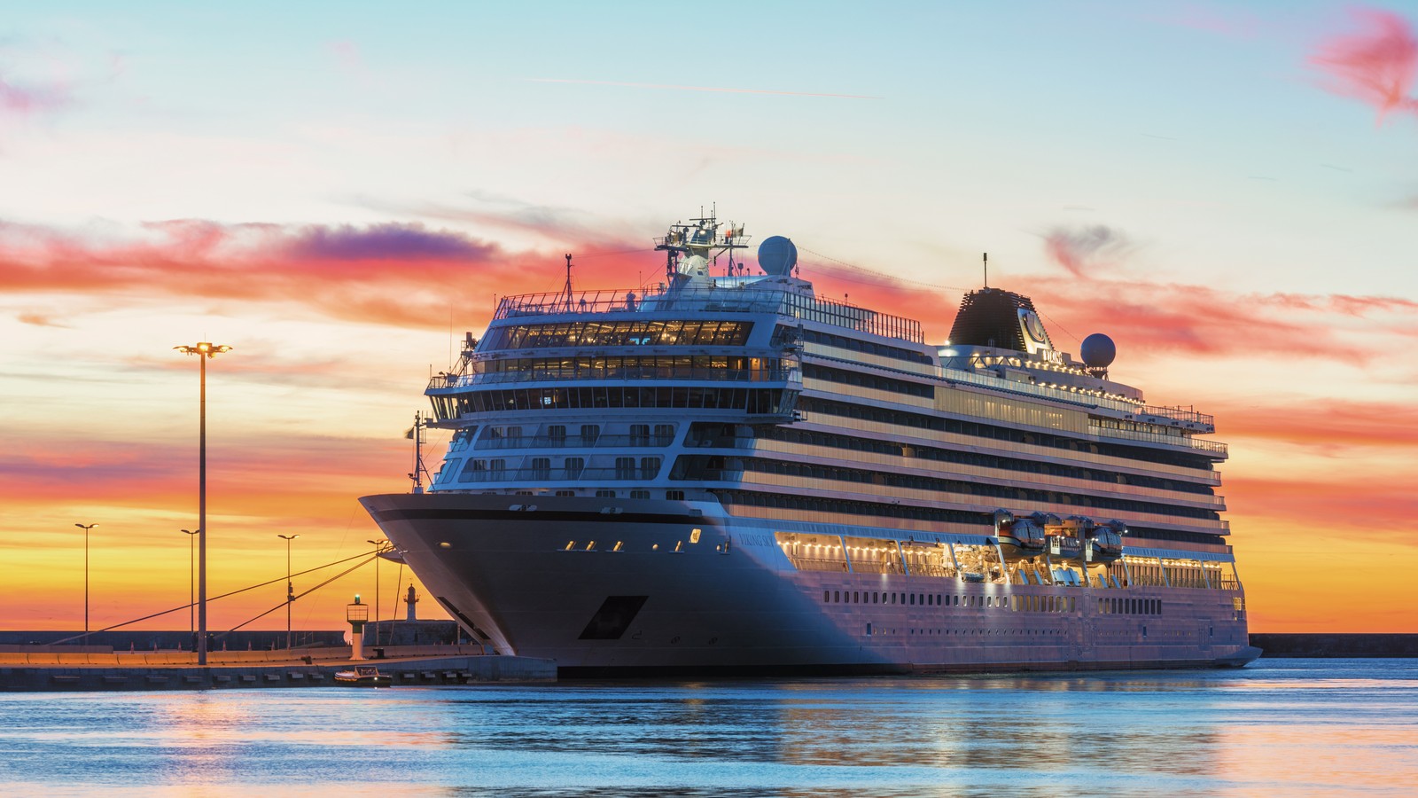 Viking Sky ocean cruise ship moored in harbor under clear sky