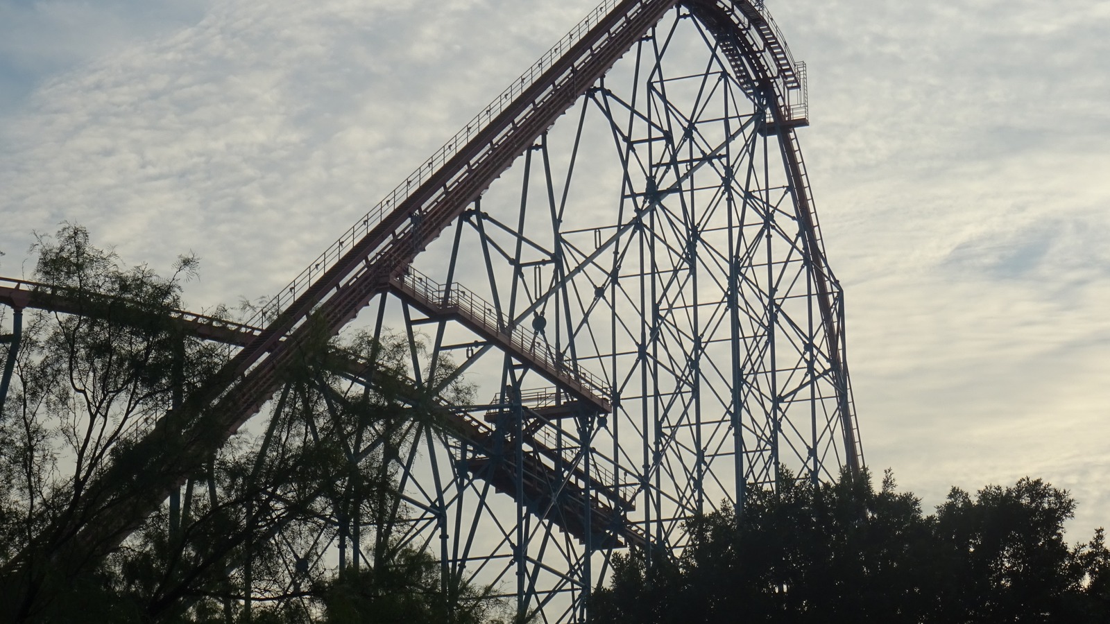 Titan roller coaster steel structure at Six Flags Over Texas in Arlington, Texas under a bright sky