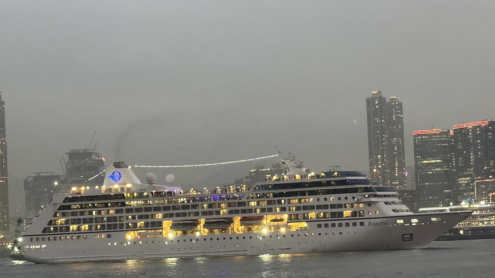 Oceania Cruises Regatta docked at Hong Kong Ocean Terminal with ship name visible on the bow