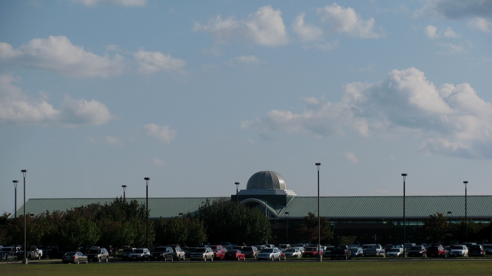 Lynchburg Regional Airport terminal and apron area under daylight with aircraft and ground activity