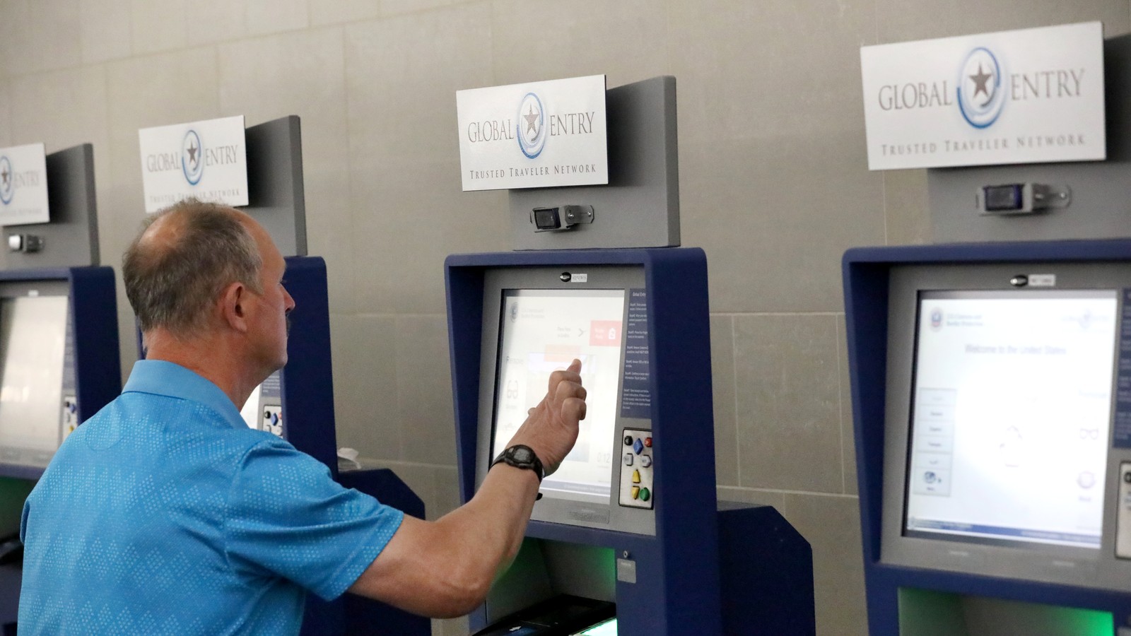 U.S. Customs and Border Protection international arrival processing area with traveler compliance kiosks under bright terminal lighting