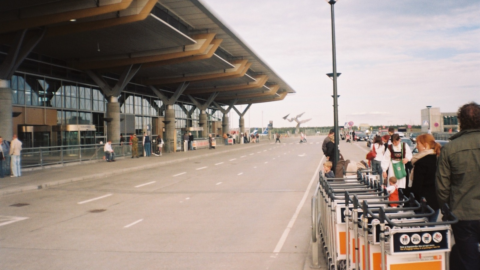 Oslo Airport Gardermoen terminal entrance and departure roadway under a blue sky