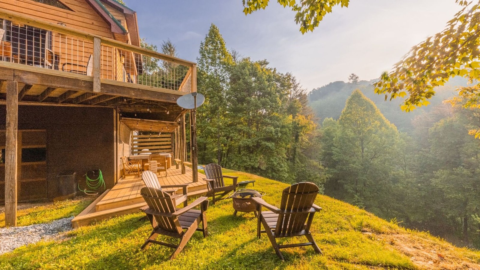 Cabin deck and fire pit at Three Little Bears Retreat with mountain hillside beyond