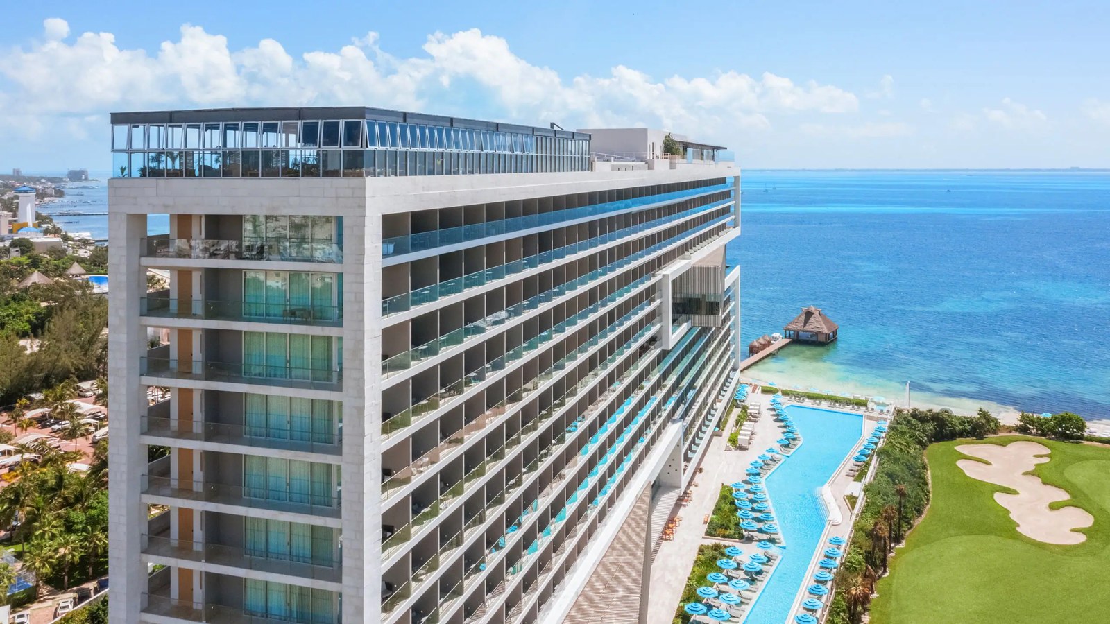 Aerial view of Hyatt Vivid Cancun beside the Caribbean Sea with its main pool and golf course