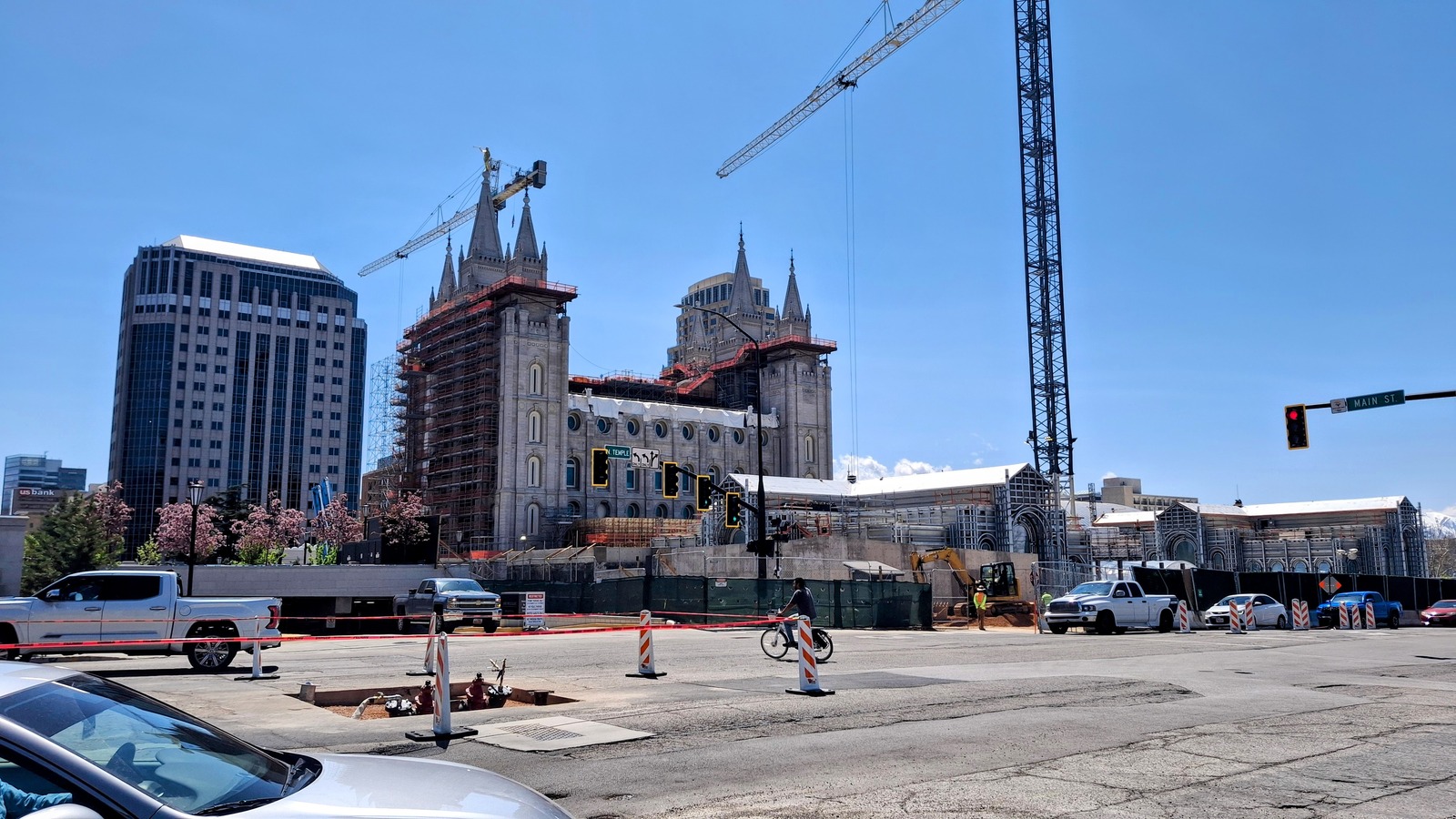 Salt Lake Temple exterior on Temple Square during renovation, with scaffolding visible around the towers in daylight
