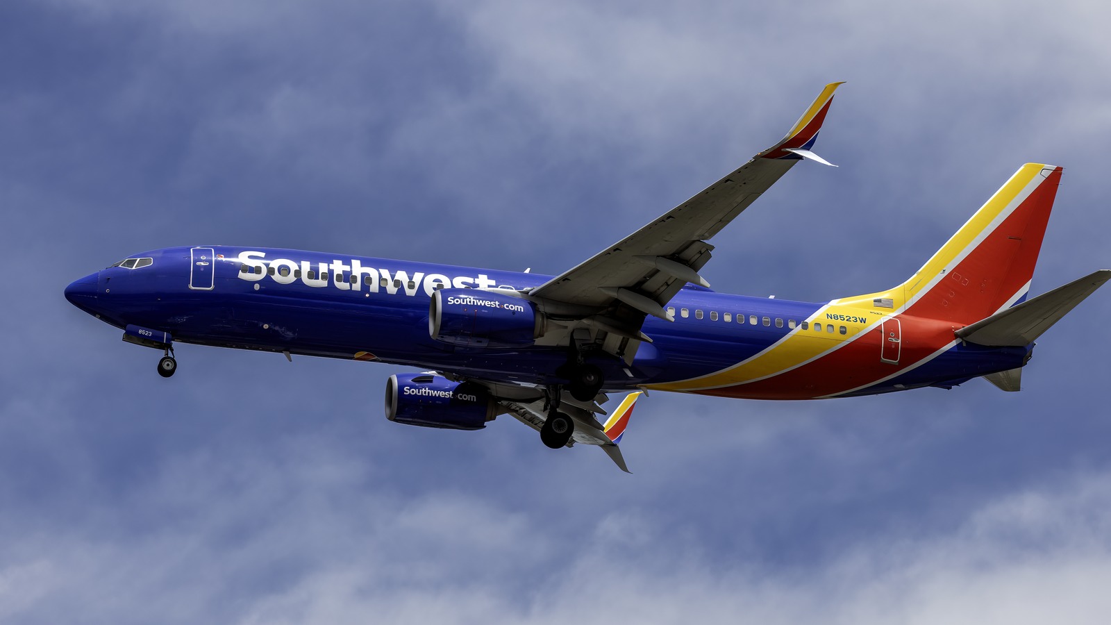 Southwest Airlines Boeing 737-800 in blue canyon blue livery climbing against a cloudy sky