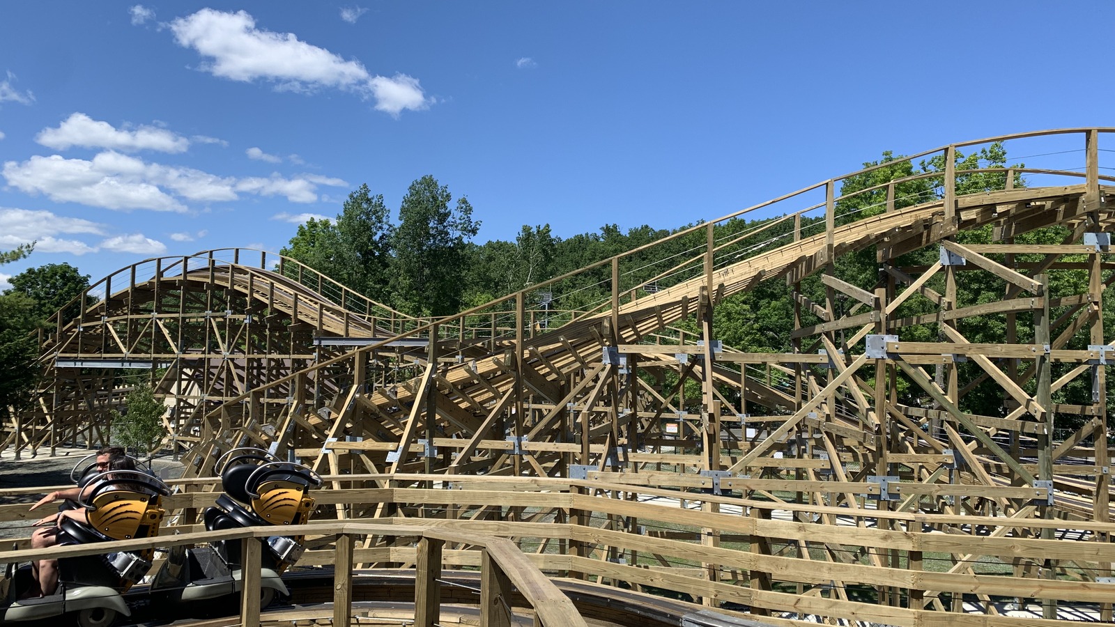 The Bobcat wooden roller coaster structure and yellow train seats at Great Escape in Queensbury New York