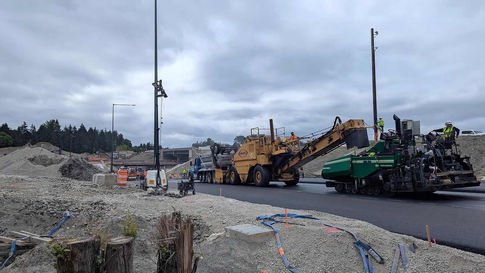 Paving crews and heavy equipment working at the I-405 Northeast 85th Street interchange in 2026