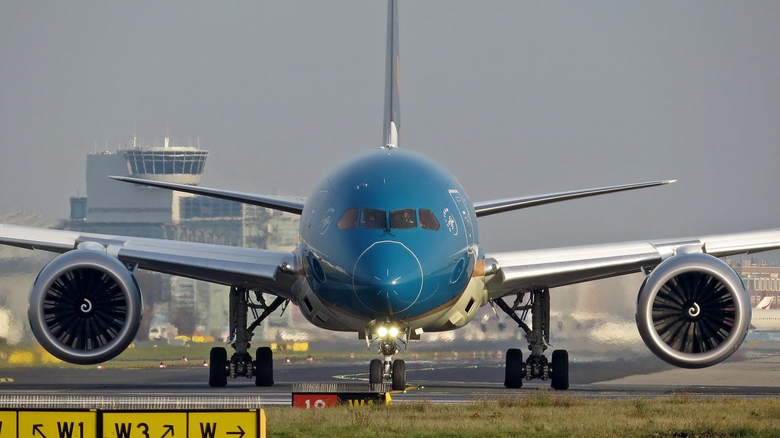 Vietnam Airlines Boeing 787-9 nose view on a taxiway with landing lights on