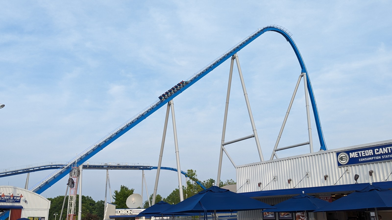 Orion roller coaster lift and blue track at Kings Island under a clear sky