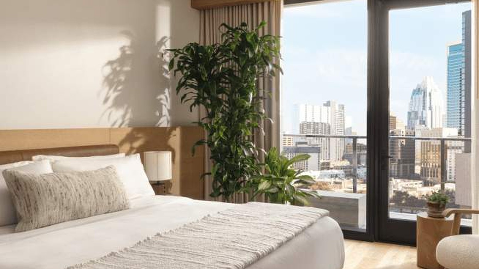 1 Hotel Austin guest room with king bed, wood textures, and bright natural light from a large window
