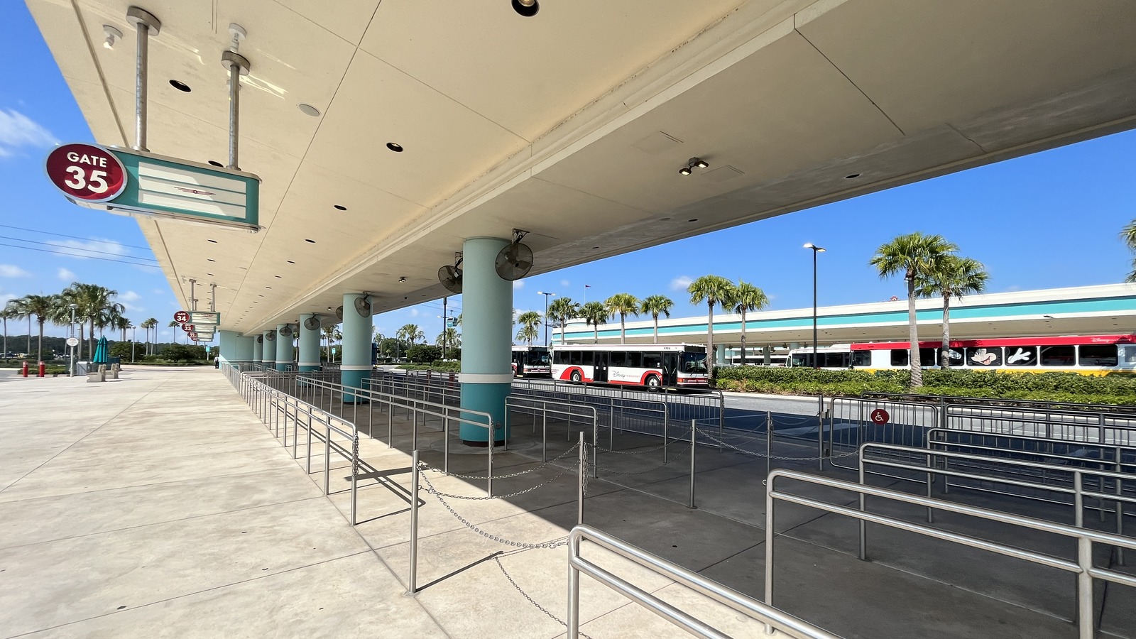 Disney Transport bus stopped at a Walt Disney World hotel bus canopy in daylight