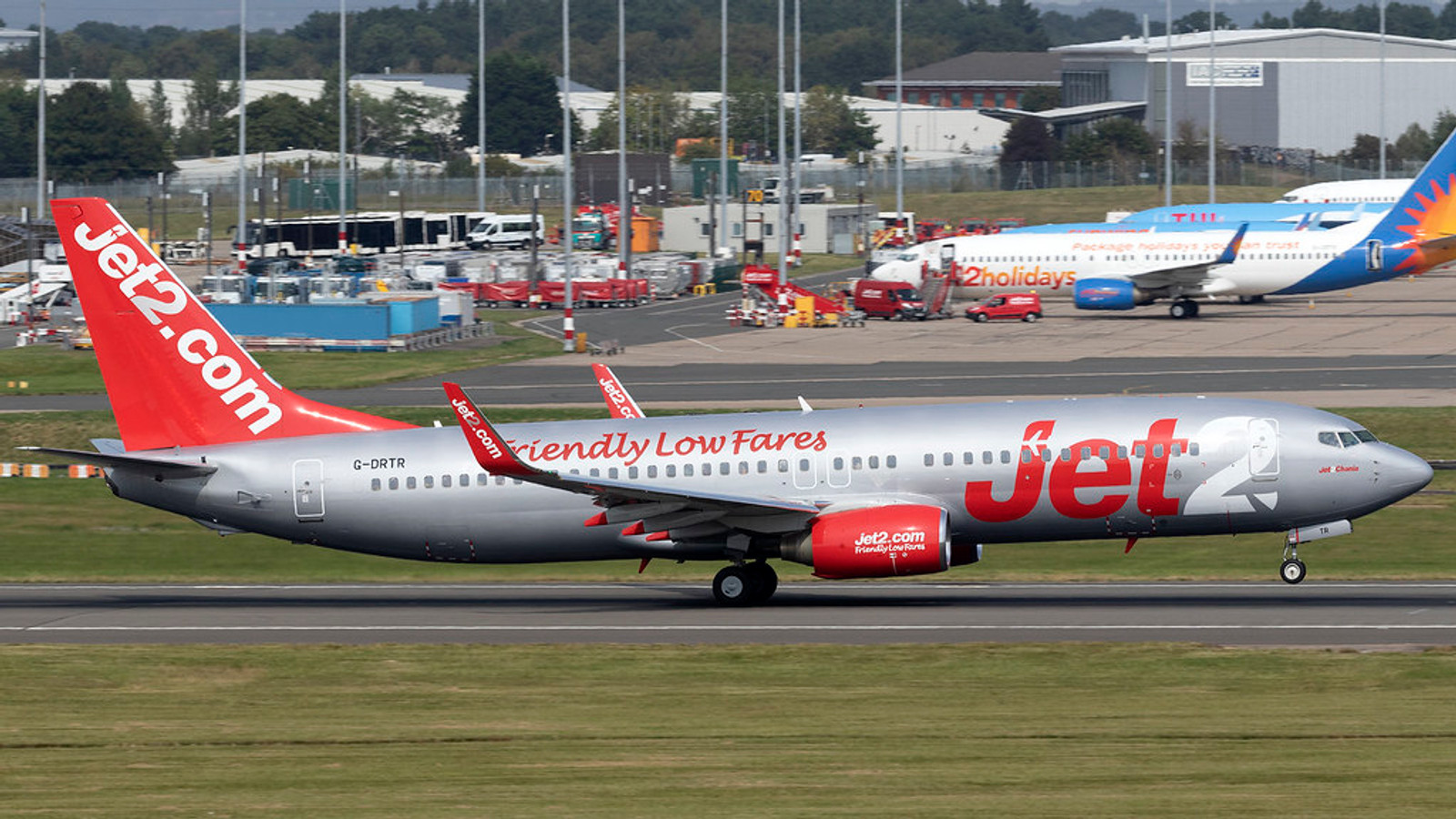Jet2 Boeing 737 at Birmingham Airport with terminal activity behind it