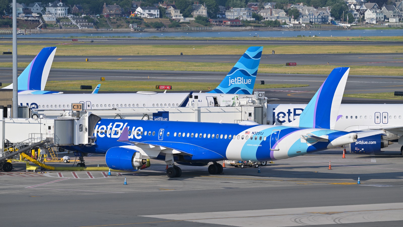 JetBlue Airbus A220 at a Boston Logan Terminal C gate near the BlueHouse lounge area