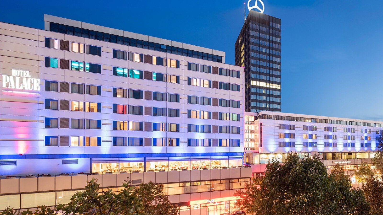 Official dusk facade of Hotel Palace Berlin with the current Palace sign lit