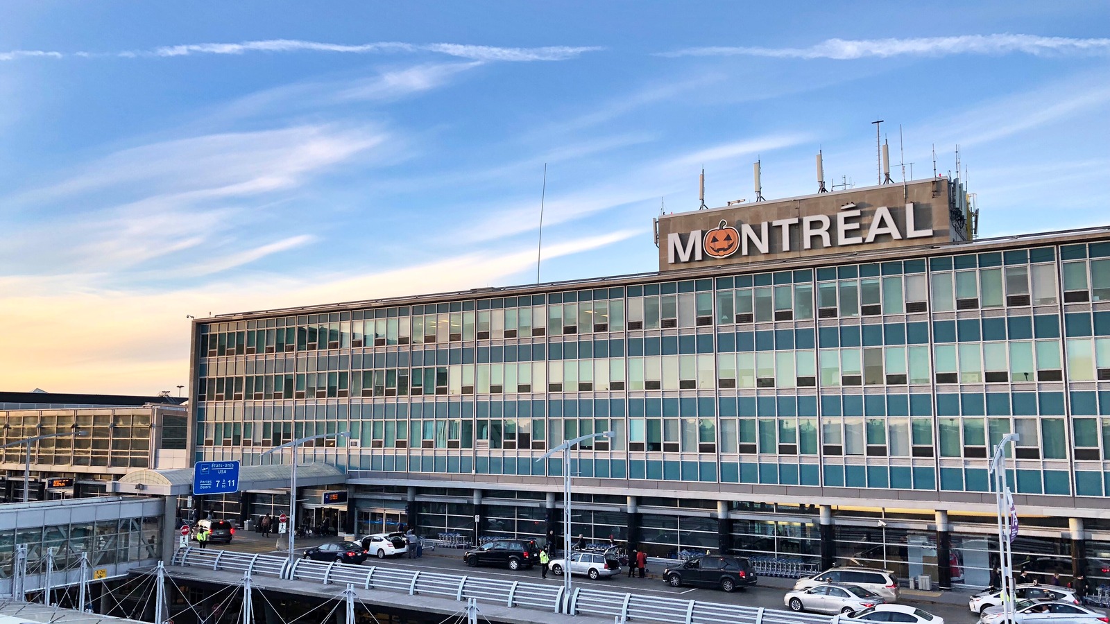 Montreal Trudeau airport terminal exterior with Montreal rooftop sign