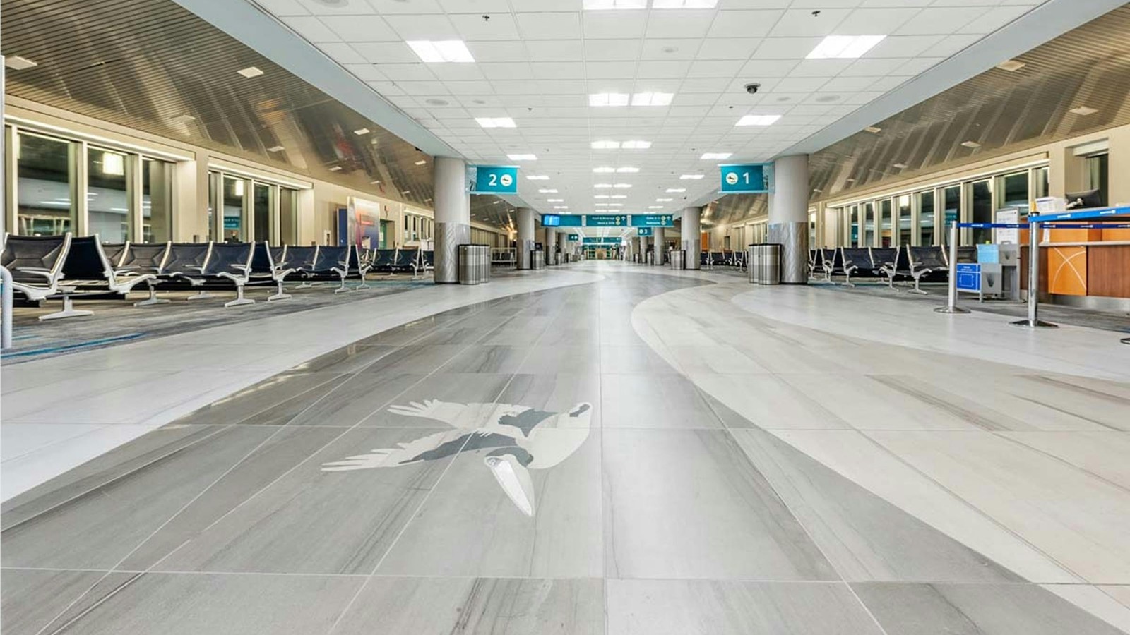 Pensacola International Airport terminal concourse with pelican floor mosaic and gates 1 and 2