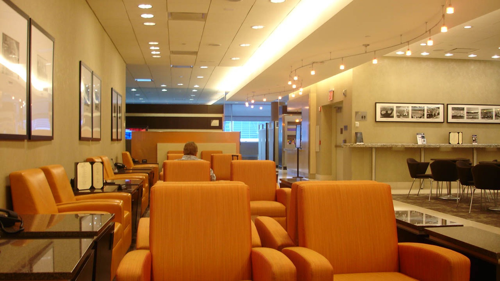 Interior seating and windows inside an American Airlines Admirals Club lounge