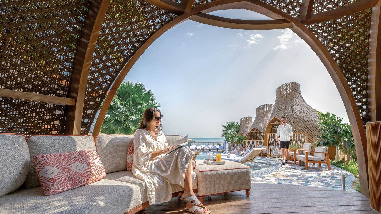 Shaded poolside seating at a Hilton portfolio resort used for the Flexible Stays Middle East offer